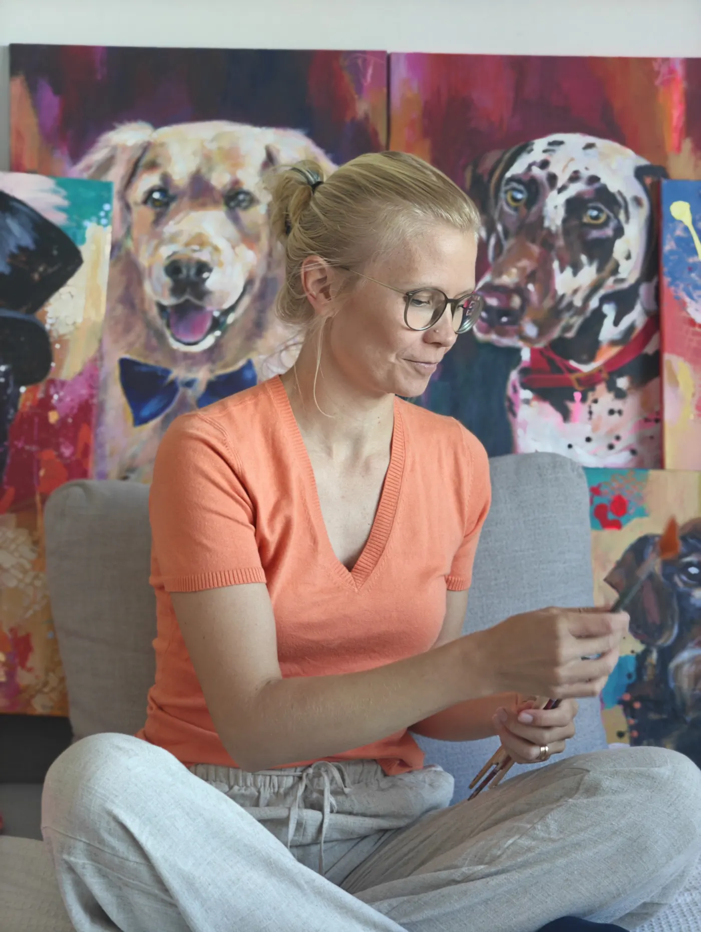 Emma-Sofia with paintings in the studio